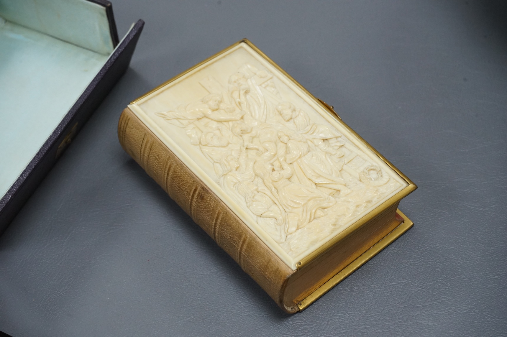 A leather boxed Common Prayer book with relief Crucifixion scene and advertising ink blotter, The Brazilian Submarine Telegraph 13cm high